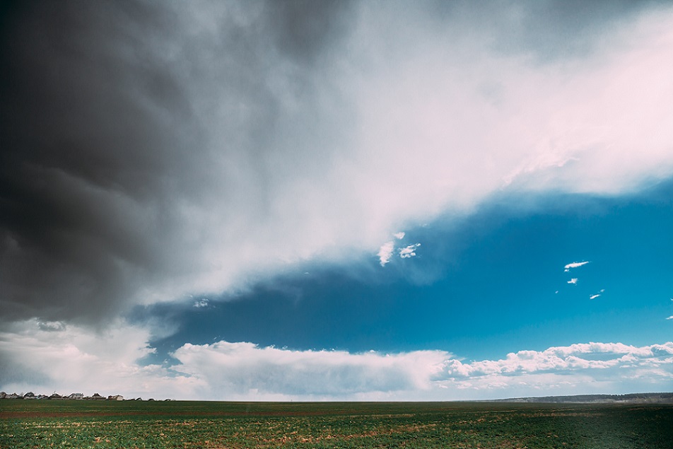 Countryside Rural Field Spring Meadow During Rain. Rain Clouds On Horizon. Agricultural And Weather Forecast Concept.